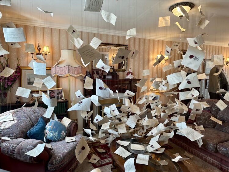 Inside Privet Drive with letters to Hogwarts flying around the room at Harry Potter Studio Tour