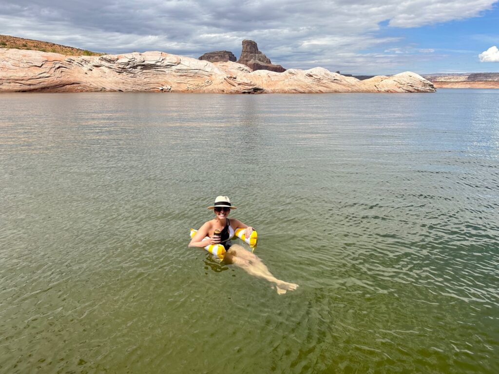 Kristy floating in the water in Lake Powell, Utah