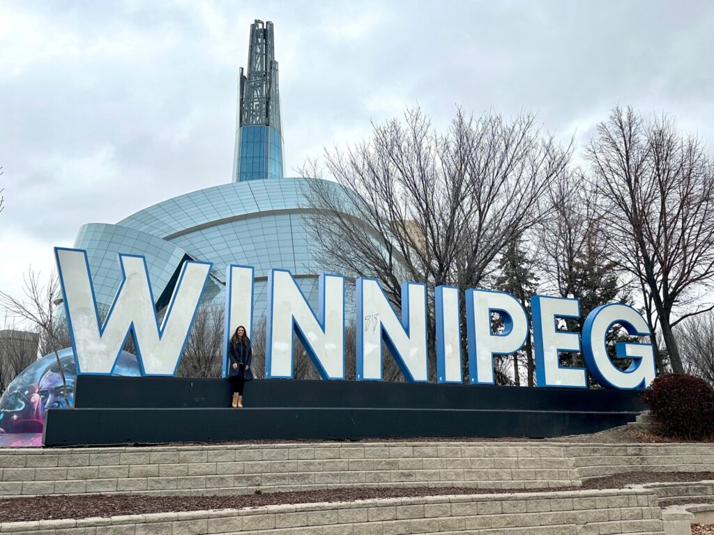 Kristy in Winnipeg, Canada by the Winnipeg sign