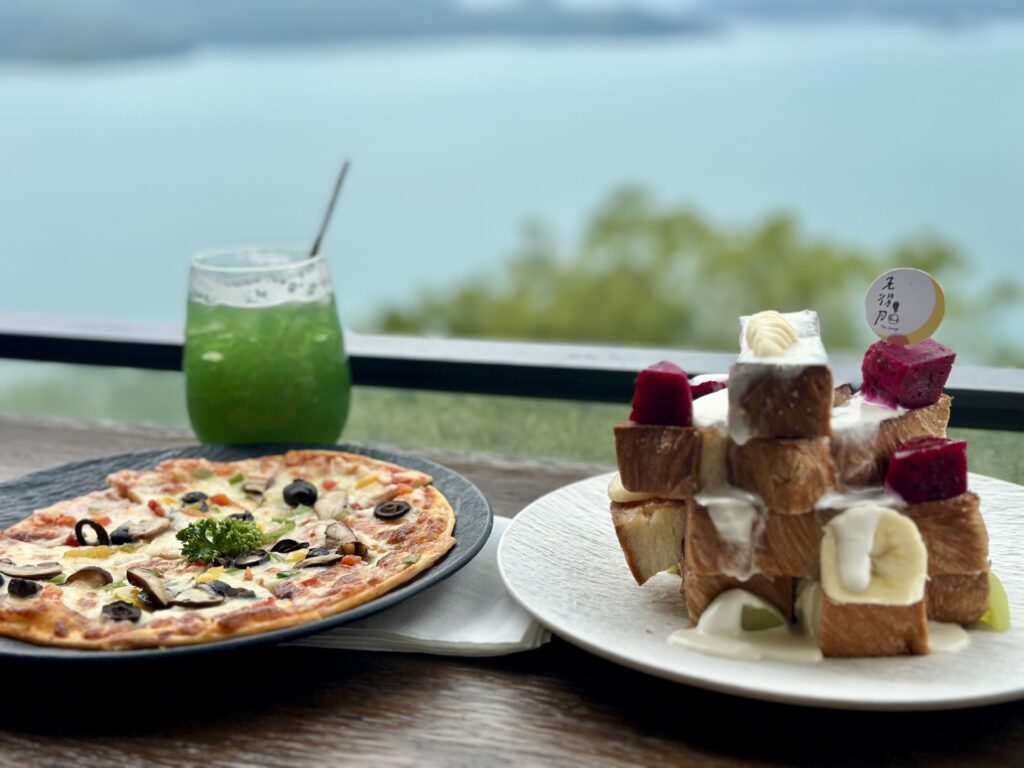 Plates with food on the restaurant balcony overlooking Sun Moon Lake at Closertolake Tea Lounge